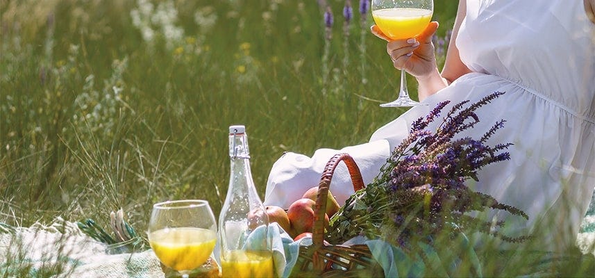 pregnant mom holding glass with mocktail